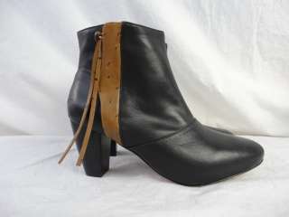 These tapered toe leather booties feature ostrich embossed trim at the 