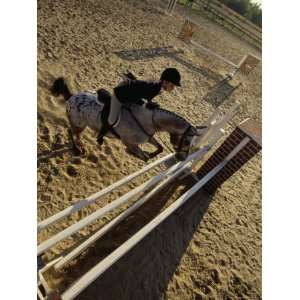   Angle View of a Woman Riding a Horse over a Hurdle Giclee Poster Print