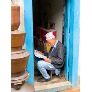 Hindu Man Reading Paper in Doorway of Bhaktapur, Kathmandu, Nepal 