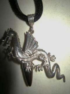 Happy flying Dragon pendant in sterling silver, with clear natural 